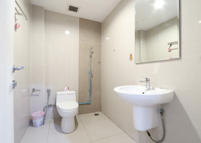 Modern bathroom with shower, sink, and toilet