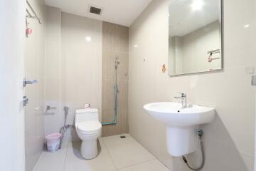 Modern bathroom with shower, sink, and toilet