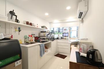 Modern kitchen with various appliances and a clean, sleek design