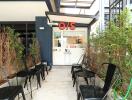 Entrance to a small commercial building with chairs outside