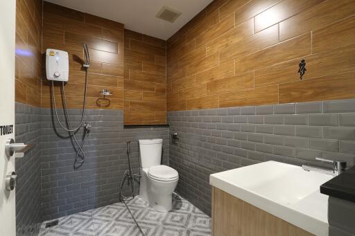 Modern bathroom with wood and gray tile design