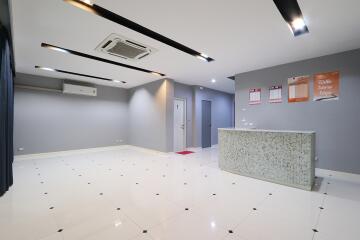 Modern lobby area with tiled flooring and a reception desk