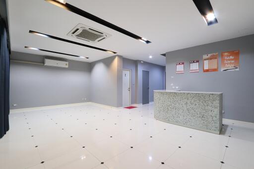 Modern lobby area with tiled flooring and a reception desk