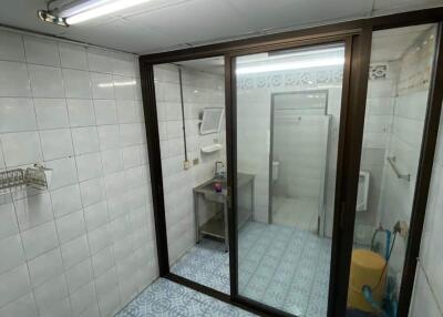 Modern bathroom with glass shower enclosure and tiled flooring