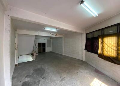 Spacious unfinished room with concrete floor and fluorescent lighting