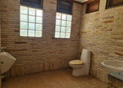 Modern bathroom with glass block windows and brick walls