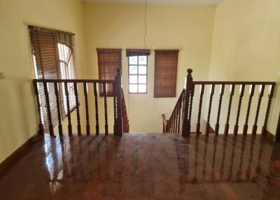 Wooden stairway landing with windows