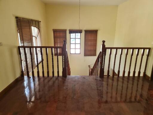 Wooden stairway landing with windows