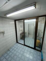 Clean tiled bathroom with sliding glass doors