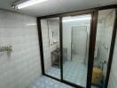 Clean tiled bathroom with sliding glass doors