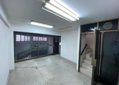 Lobby area with tiled floor and staircase