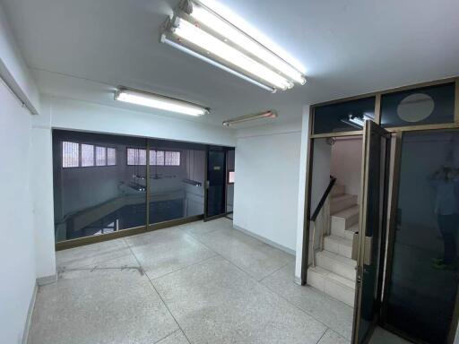 Lobby area with tiled floor and staircase