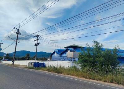 Exterior view of a blue-roofed building along a road