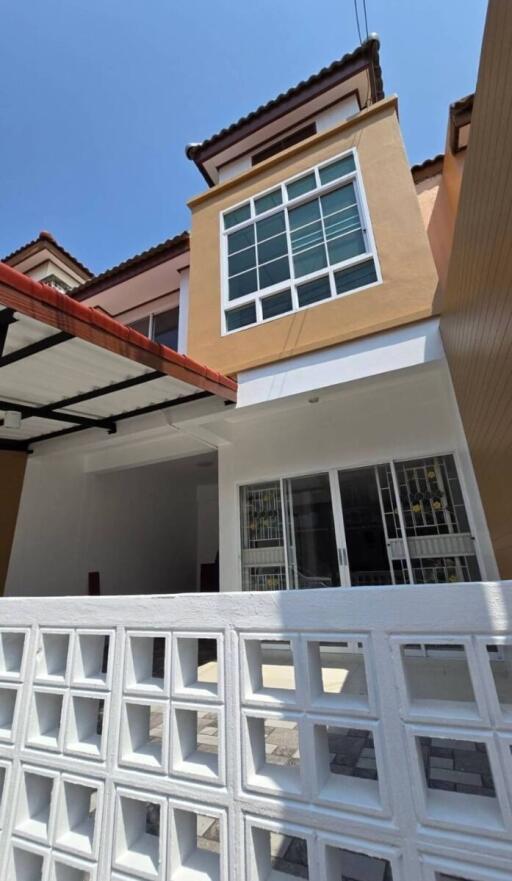 Front view of a modern two-story house with a carport