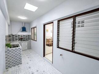 Modern kitchen with tiled flooring and backsplash