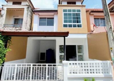 Front view of a two-story house with a gated entrance