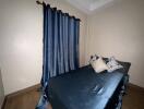 Bedroom with a double bed and blue curtains