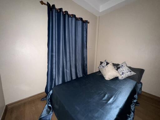 Bedroom with a double bed and blue curtains
