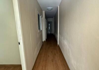 Interior hallway with wooden flooring and white walls