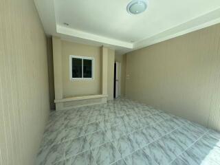 empty room with tiled floor and small window