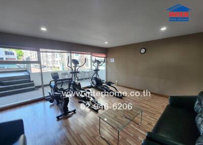 Well-lit exercise room with modern workout equipment