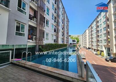 Outdoor view of apartment complex with swimming pool