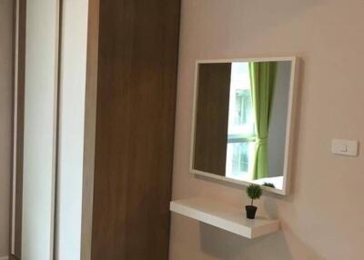 Bedroom with wardrobe, wall-mounted air conditioner, mirror, and stool