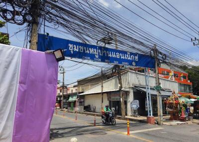 Street view with electrical wires and neighborhood sign