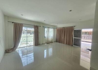 spacious living room with large windows and patio doors