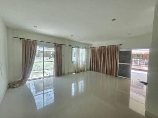 spacious living room with large windows and patio doors