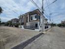 Modern residential building on a corner lot with paved streets