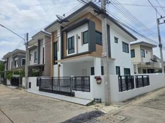 Two-story house with modern façade and gated entrance