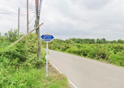 Rural road with greenery and signpost