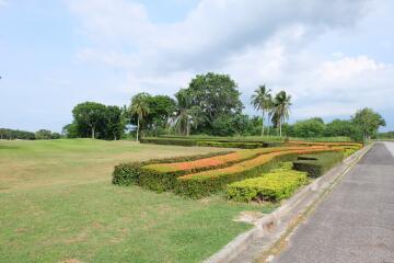 Manicured lawn and landscaped shrubs along a paved pathway