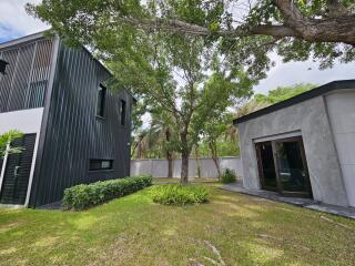 Modern exterior of a property with yard and trees