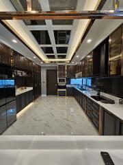 Modern kitchen with dark cabinetry and marble floor