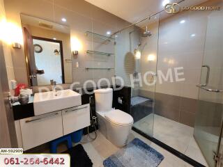 Modern bathroom with a large glass-enclosed shower, toilet, and sink