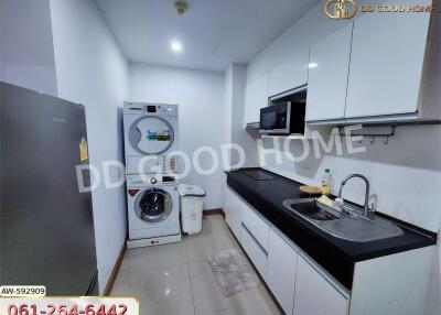 Modern kitchen with white cabinetry and laundry appliances