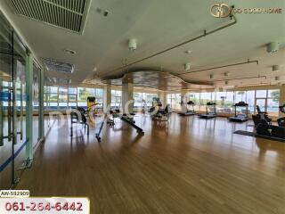 Spacious gym with exercise equipment and large windows