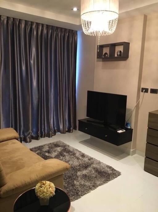 Modern living room with curtain, TV, and chandelier