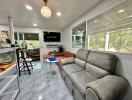 Modern living room with large windows and gray sofa