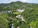 Aerial view of a verdant landscape with houses and roads