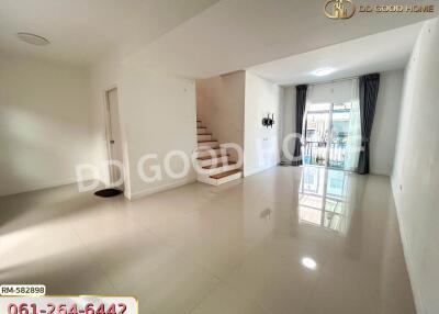 Bright and spacious living room with staircase