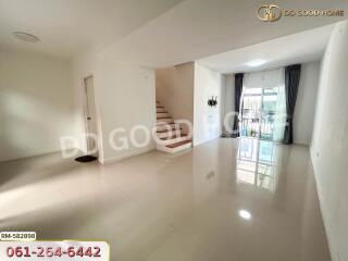 Bright and spacious living room with staircase