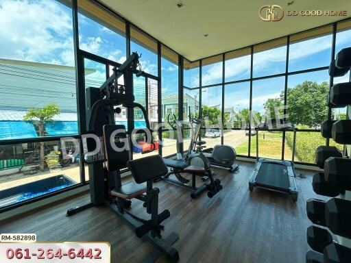 Home gym with large windows and modern exercise equipment