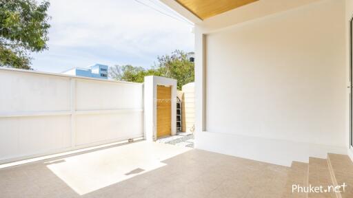 Modern outdoor area with gate and tiled floor