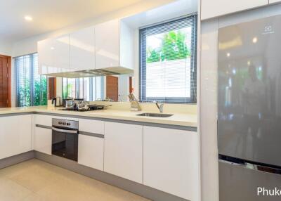 Modern kitchen with white cabinets and stainless steel appliances