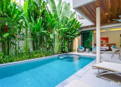 Outdoor pool area with greenery and seating