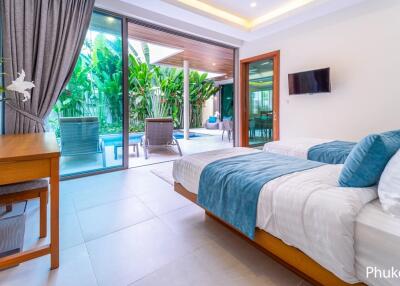 Modern bedroom with pool view and twin beds