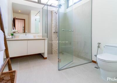 Modern bathroom with glass shower and white fixtures